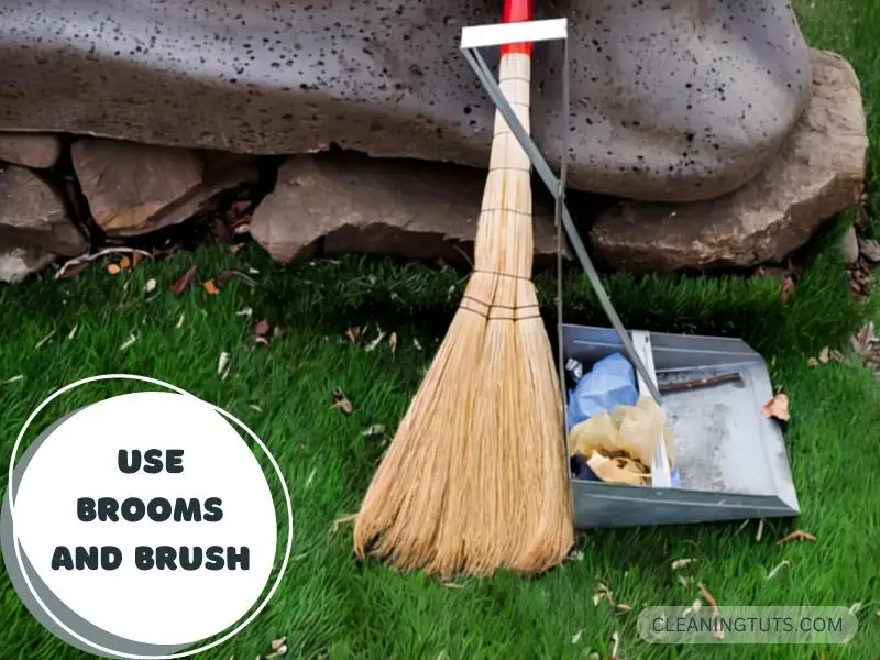 Brooms and other tools on artificial grass