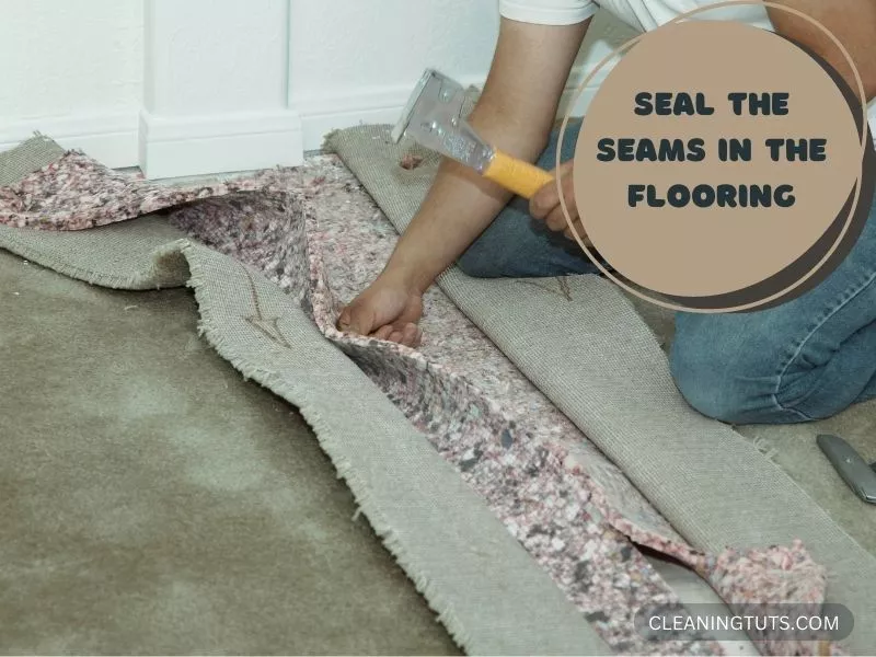 A man Sealing the Seams in the Flooring