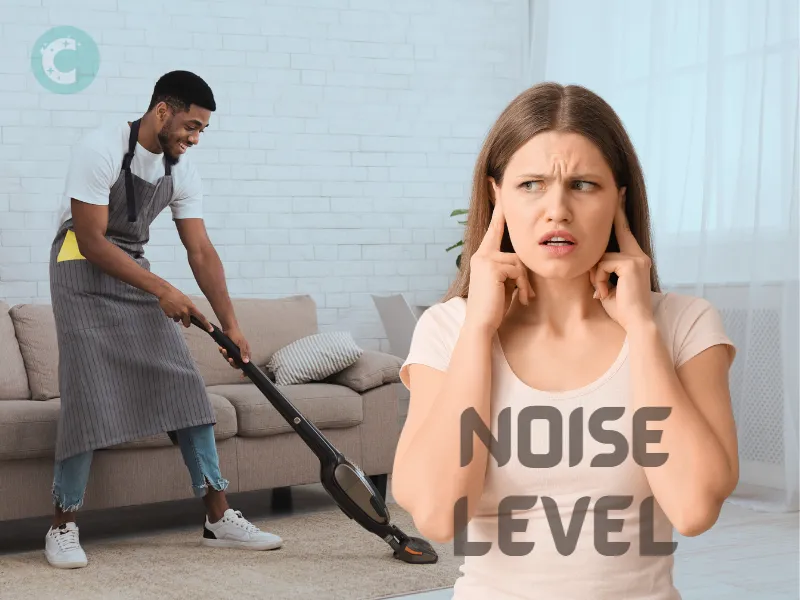 A lady holding her ears due to vacuum noise in the background 