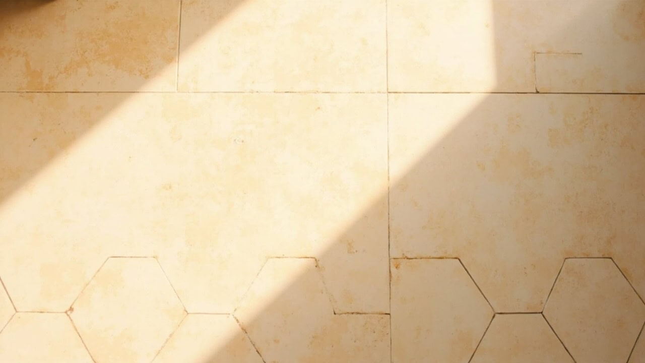 Clean ceramic tile floor with visible grout lines after proper mopping technique